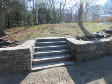 Stone retaining wall and large stone steps