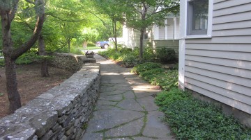 Stone wall, natural stone sidewalk with perennial border