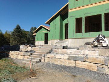 Integration of natural stone steps and retaining walls to mitigate 8′ of fill with tight site restrictions